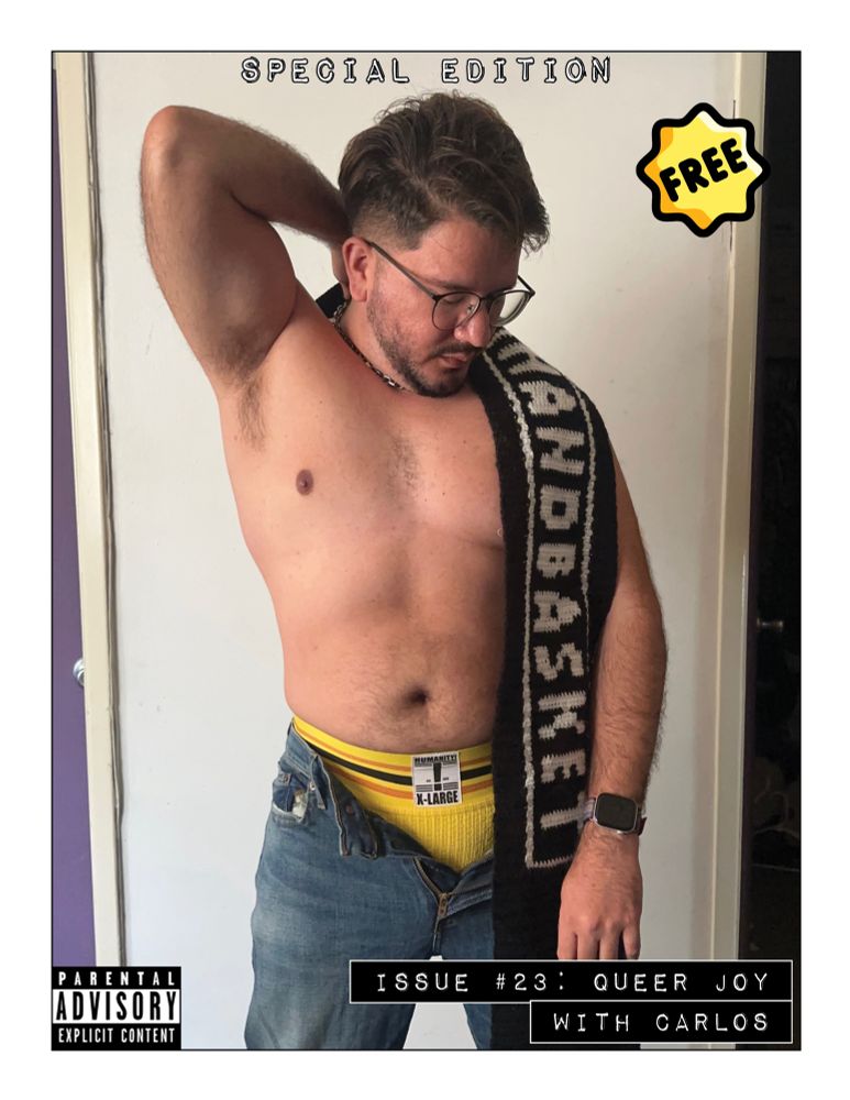 Carlos standing shirtless with their right arm up. They are looking down and toward the left. A black scarf with the Handbasket logo is draped over their left side. Their jeans are unbuttoned and zipped down, exposing a yellow jockstrap.
