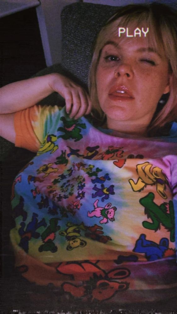 A hot woman wearing a Grateful Dead shirt