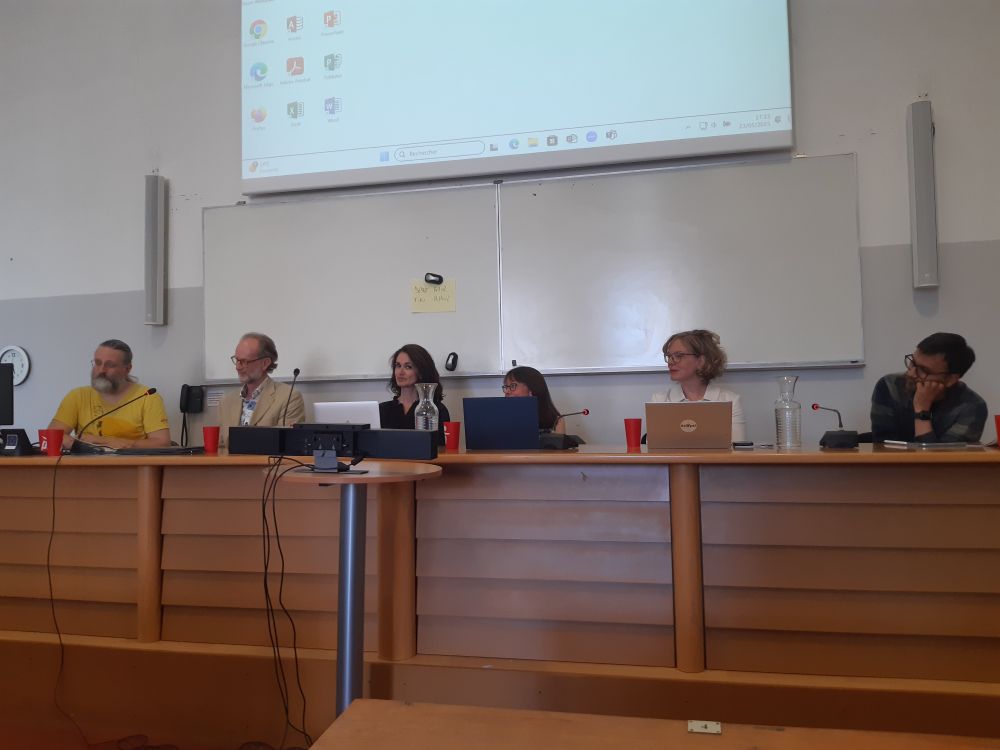 Various academic members of the NDH sitting at a desk together