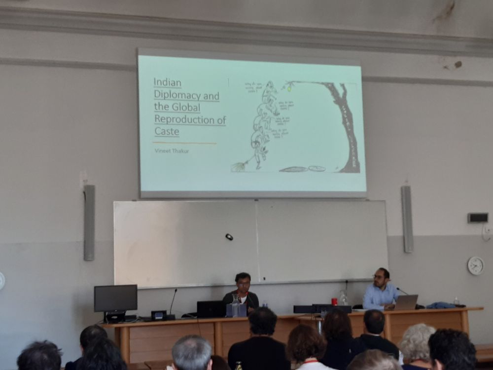 Vineet Thakur presents in front of his Powerpoint bearing the title of his presentation