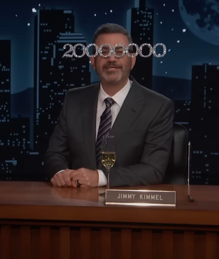 Jimmy Kimmel wearing big sparkly glasses that read '20,000,000'