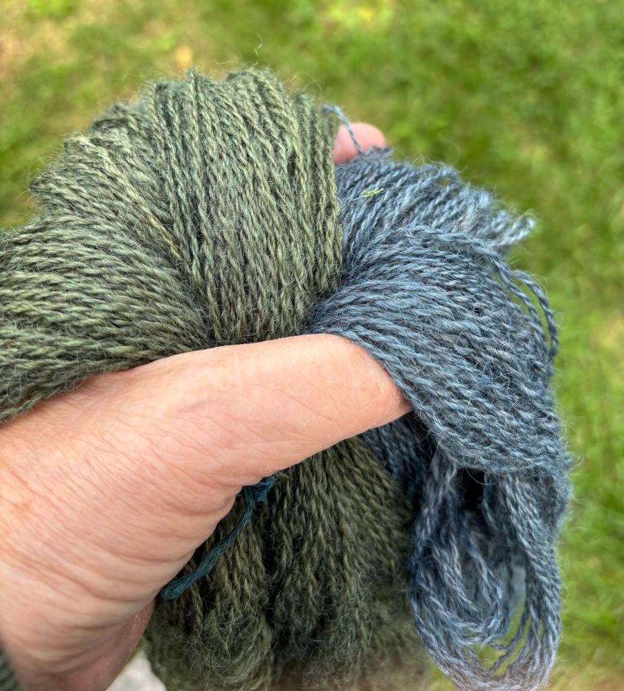 Holding green and blue yarn in my hand