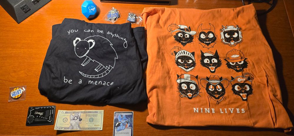 A spread of MFF swag along with two furry t-shirts 