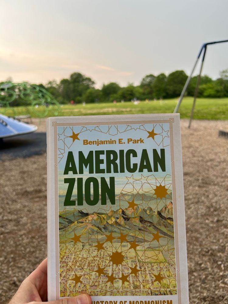 Benjamin Park’s book American Zion with a school playground and youth soccer practice in the background. 