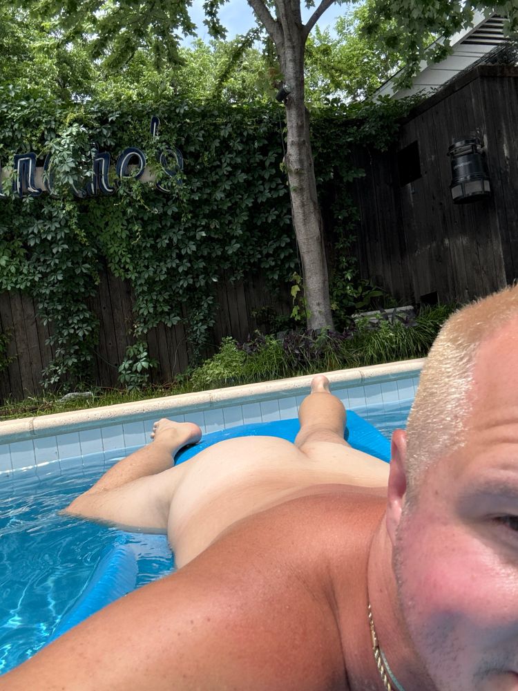 laying on pool float with my bare pale ass up trying to get tan
