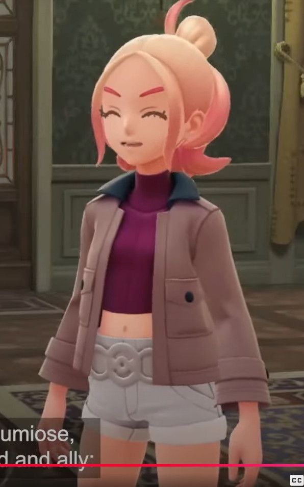 A woman with blonde hair in a crop top, a jacket, and white shorts. 