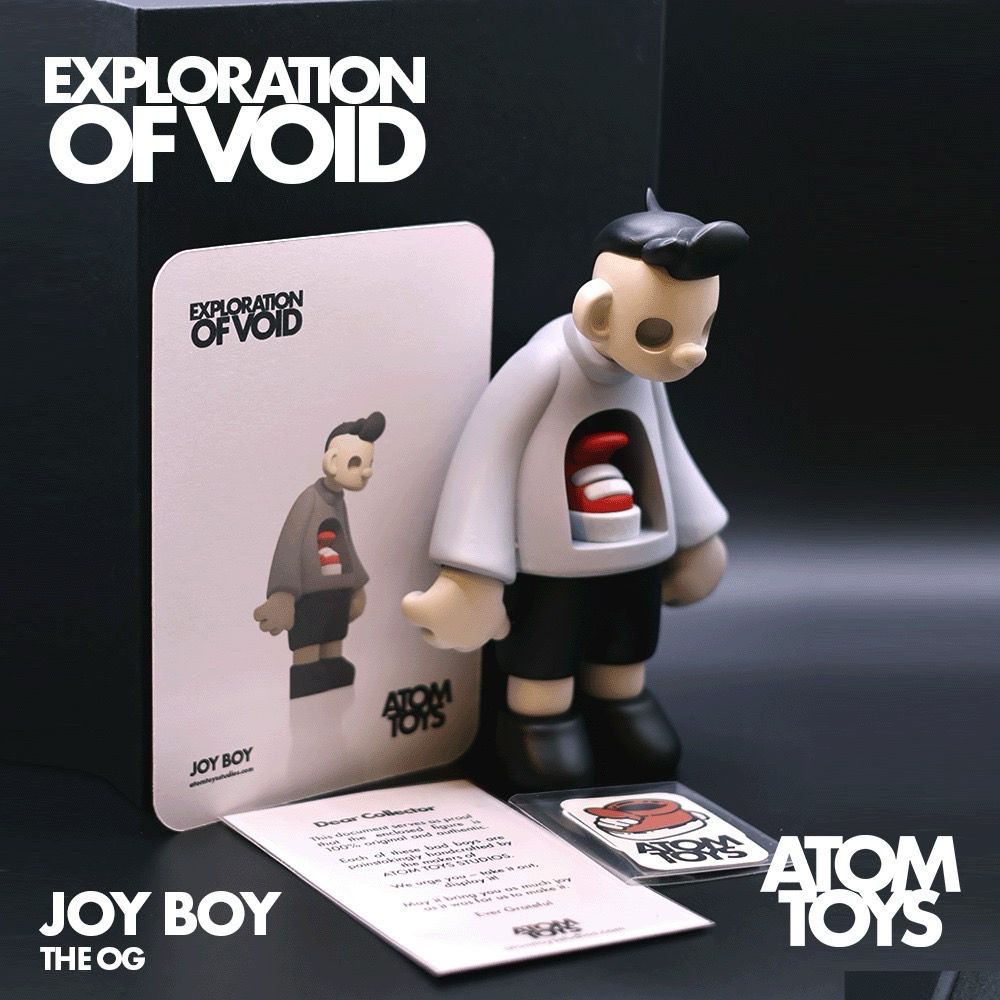 Joy Boy, the OG designer art toy, displayed alongside its custom-designed box and certificate of authenticity. This limited-edition collectible features intricate details, a sleek presentation box, and an official certificate