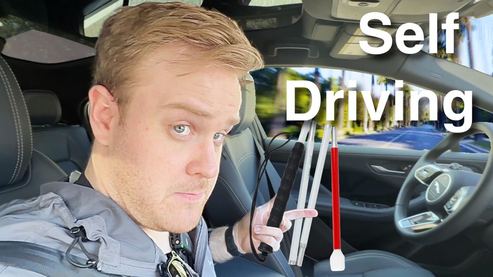 James Rath, a legally blind filmmaker with light skin and dirty blonde hair, sits in the driver’s seat of a car with the window rolled down, looking at the camera with a slightly skeptical expression. He holds a folded white cane out of the window. The car’s interior is empty, emphasizing that no one is actively driving. The background outside is blurred, suggesting motion. Large text on the right side reads “Self Driving.”