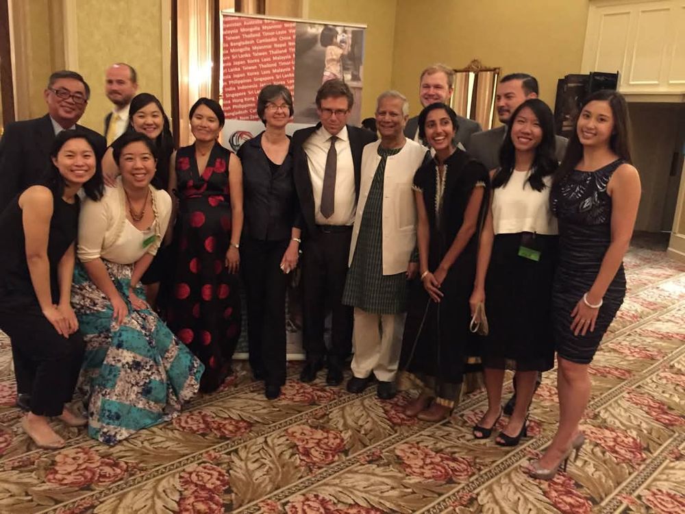 Group photo of Give2Asia staff with Muhammad Yunus