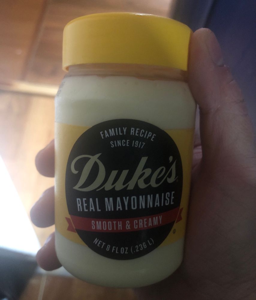 A hand holding a tiny jar of Duke’s Real Mayonnaise 