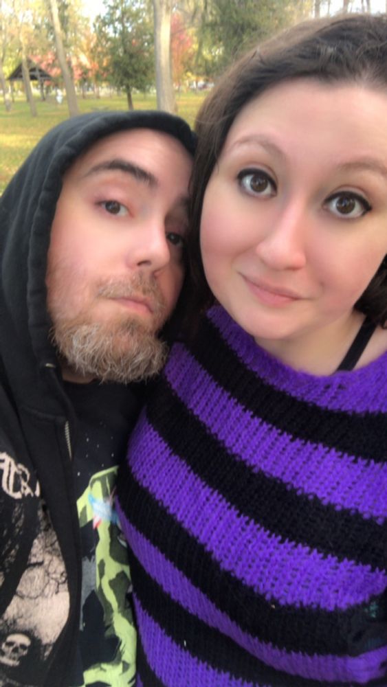 A photo of Crockett and Roxi, Crockett is wearing a black hoodie and Roxi is wearing a purple and black stripe sweater