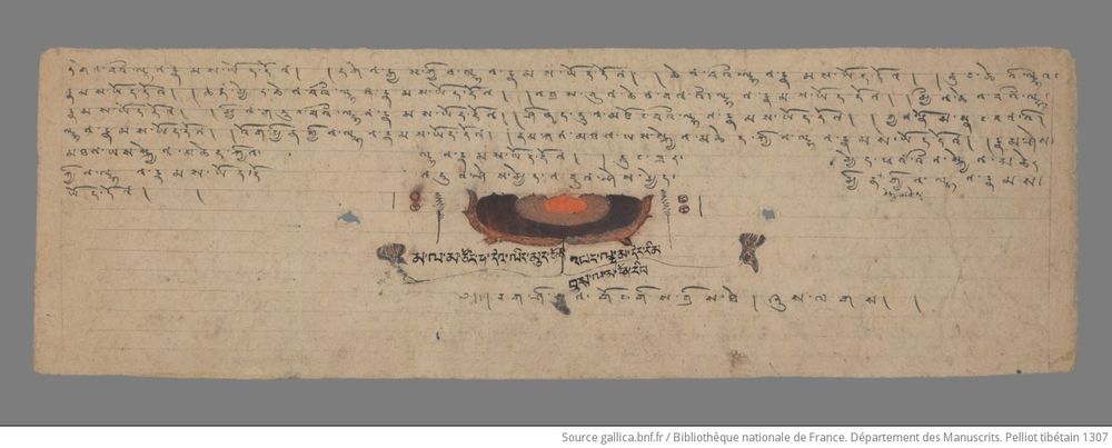 TIbetan manuscript with large lotus in color in center middle of page.