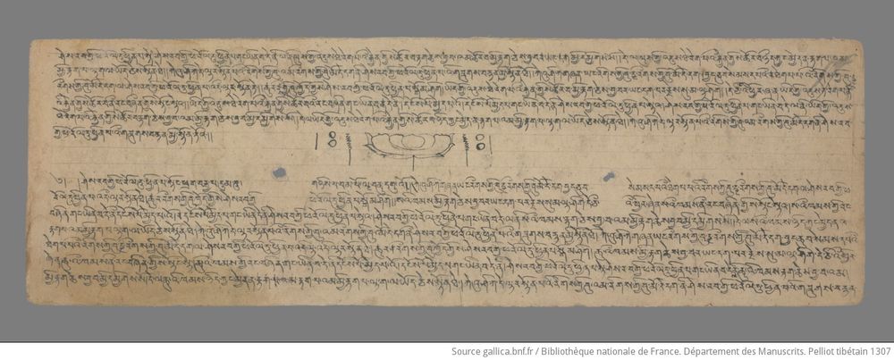Black ink lotus between two sections of Tibetan manuscript