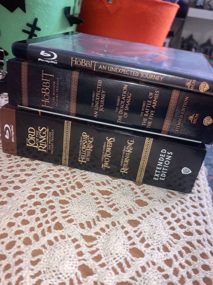 The Hobbit and The Lord of the Rings Extended Edition blu ray sets on top of an ugly af table cloth.