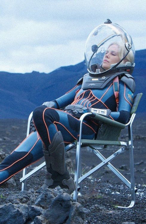 Charlize Theron, as Meredith Vickers in Prometheus, sits in her spacesuit waiting for her next scene.