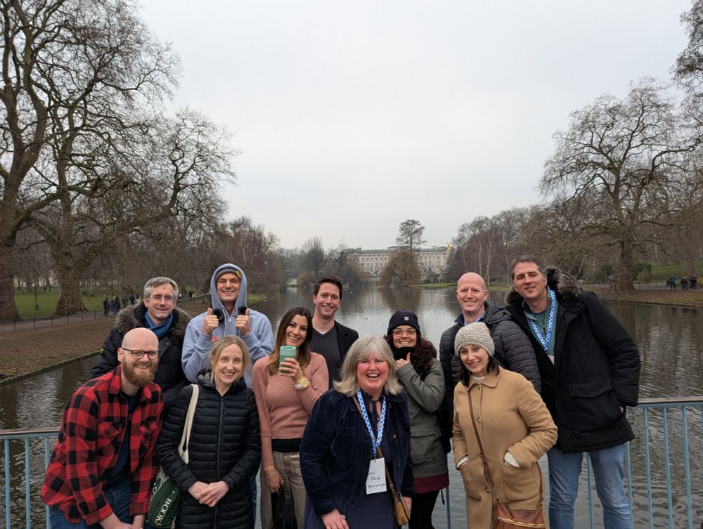 Group of 11 people including me on a bridge in St James Park with Buckingham Palace in the background 