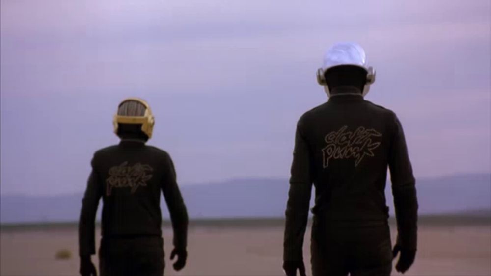 two men wearing black jackets with daft punk on the back