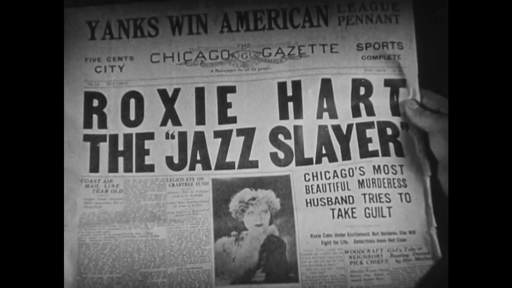 Still from the 1927 movie Chicago. A newspaper reads "ROXIE HART THE 'JAZZ SLAYER'"