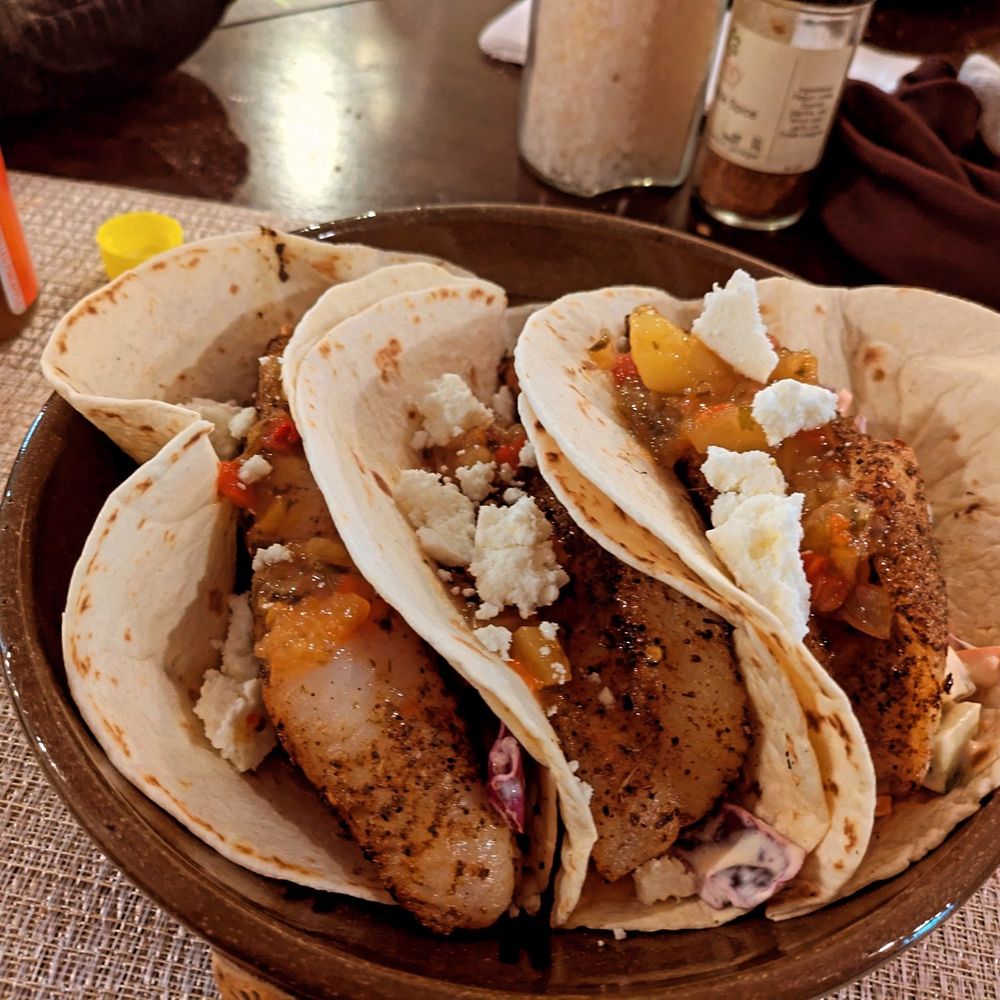 Three fish tacos with a little cojita cheese. 