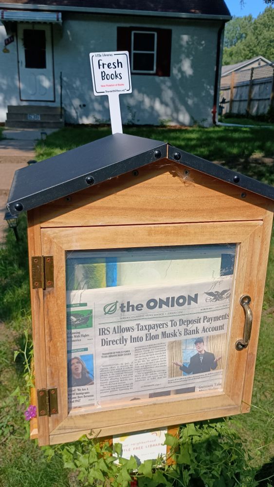 Little wood box with books and a copy of The Onion