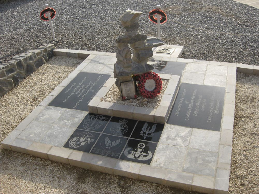Photo of an inukshuk memorial with a poppy wreath
