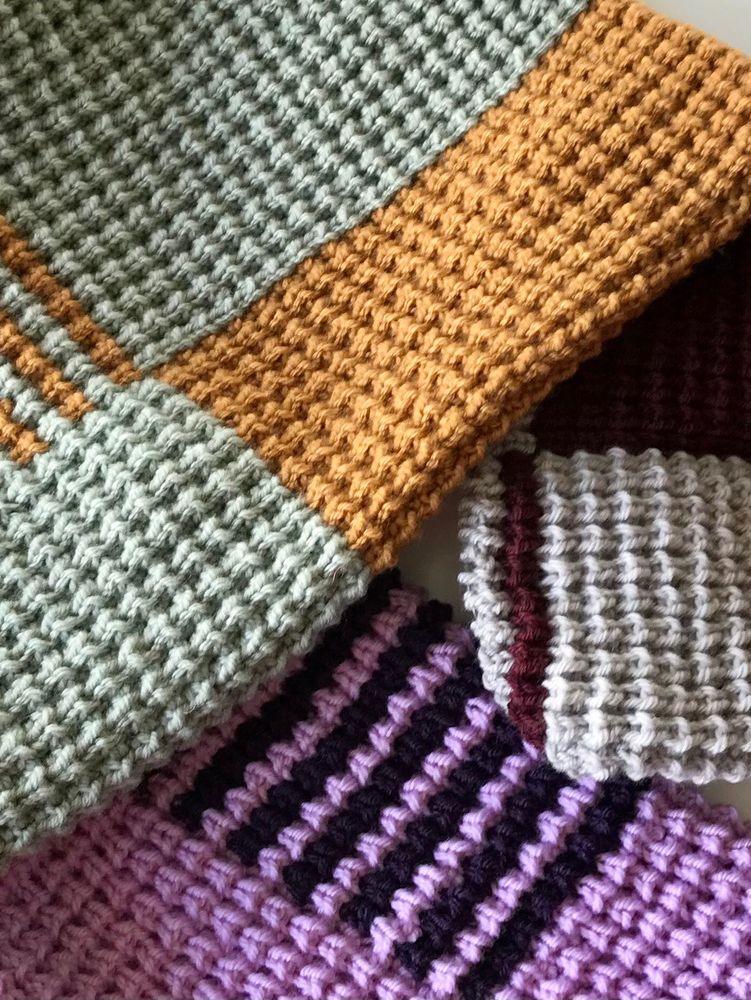Close up of a knitted ribbed texture in three different colour ways: light sage with caramel, lilac with dark purple and light grey with burgundy. 