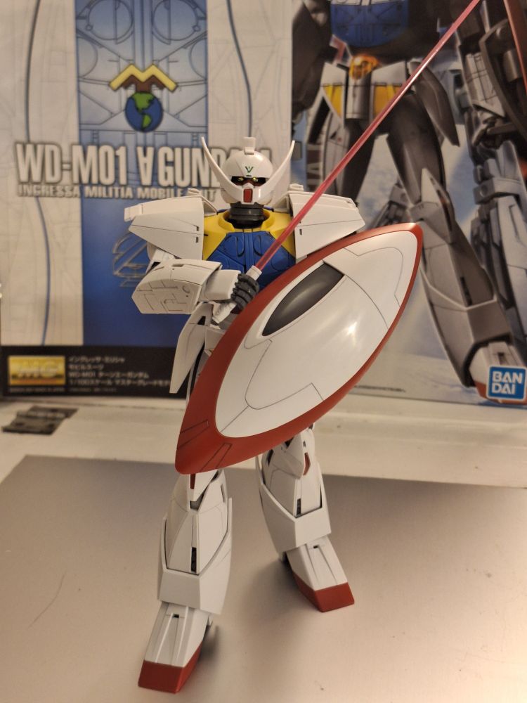 Turn A Gundam Master Grade, in a defensive pose holding up its shield and beam saber