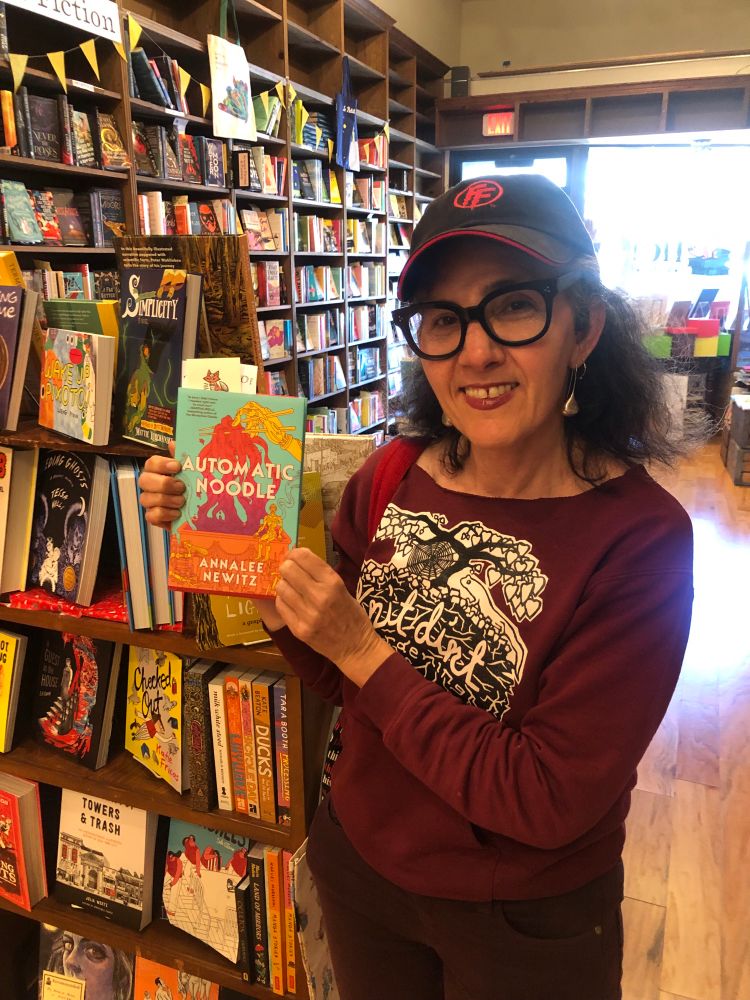 Me holding book in a bookstore 