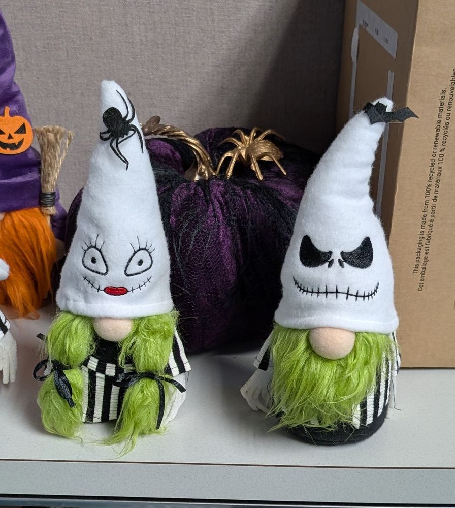 2 gnomes in what could be mistaken for Klan attire but also decorated for Halloween 