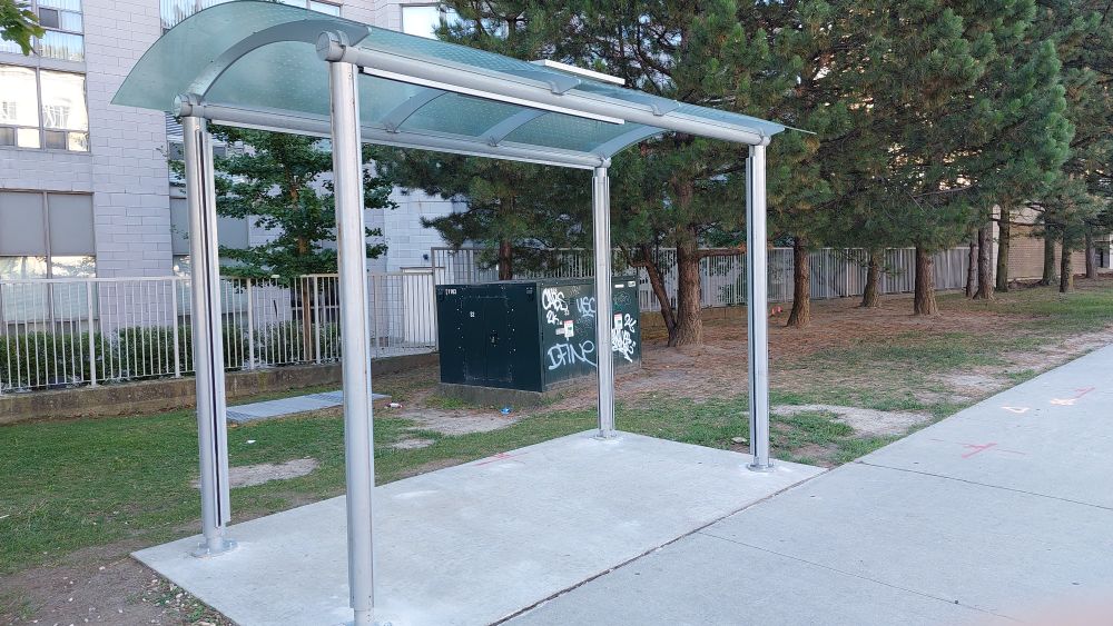 Partially installed bus shelter on the south side of Eglinton Avenue at Wynford Drive, across from the Wynford stop on the unopened Eglinton Crosstown LRT
