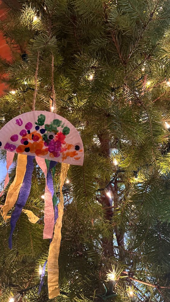 a child's art project that is very ugly hanging on a tree 