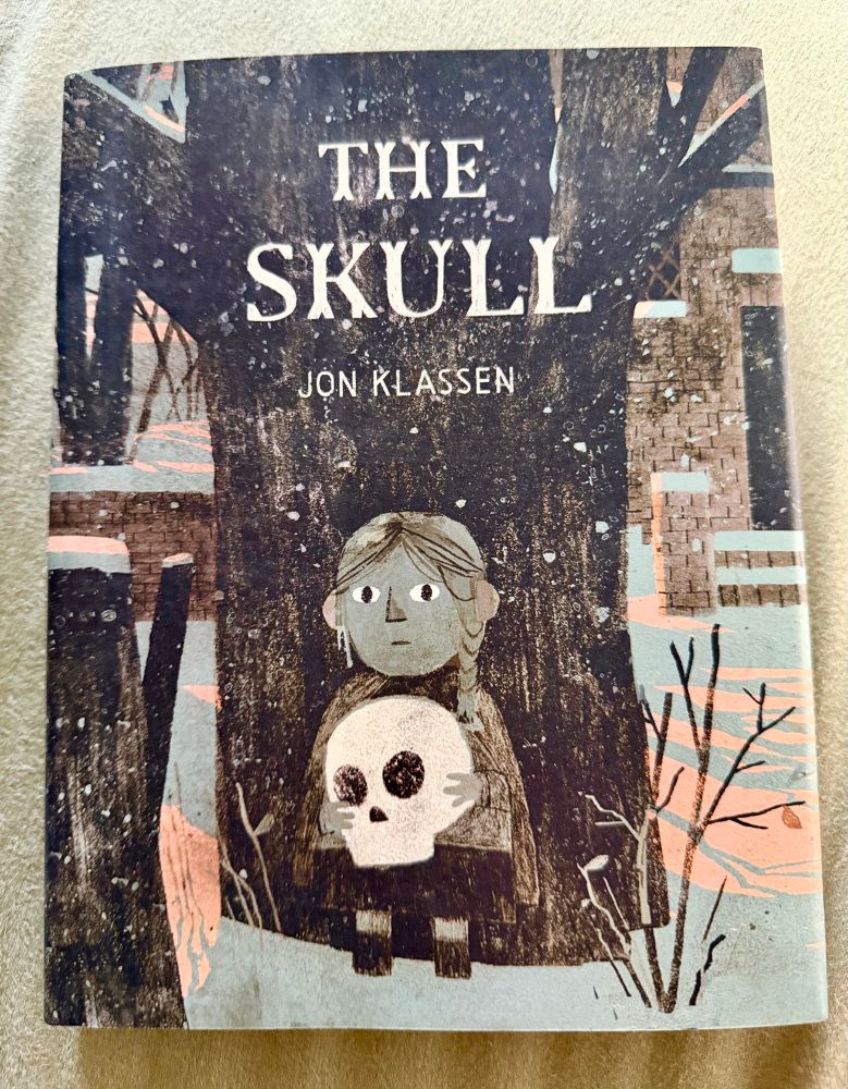 The cover of The Skull is a little girl holding a skull in front of a large dark tree. 