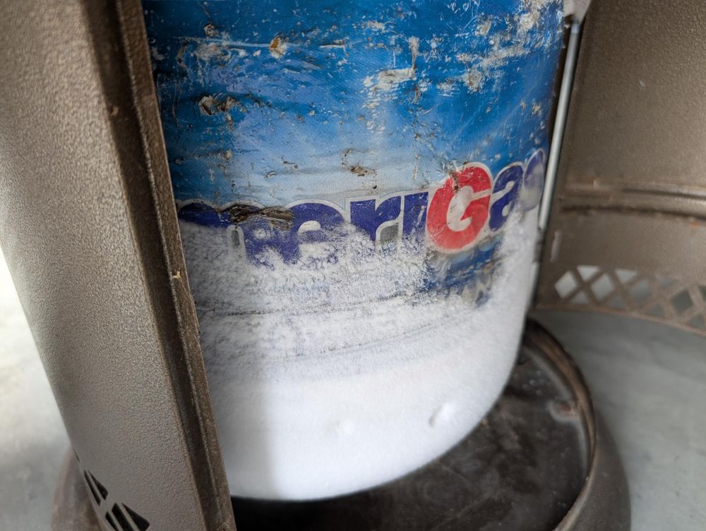 a propane cylinder inside the base of a patio heater. or is covered in a 6mm-thick later of frost