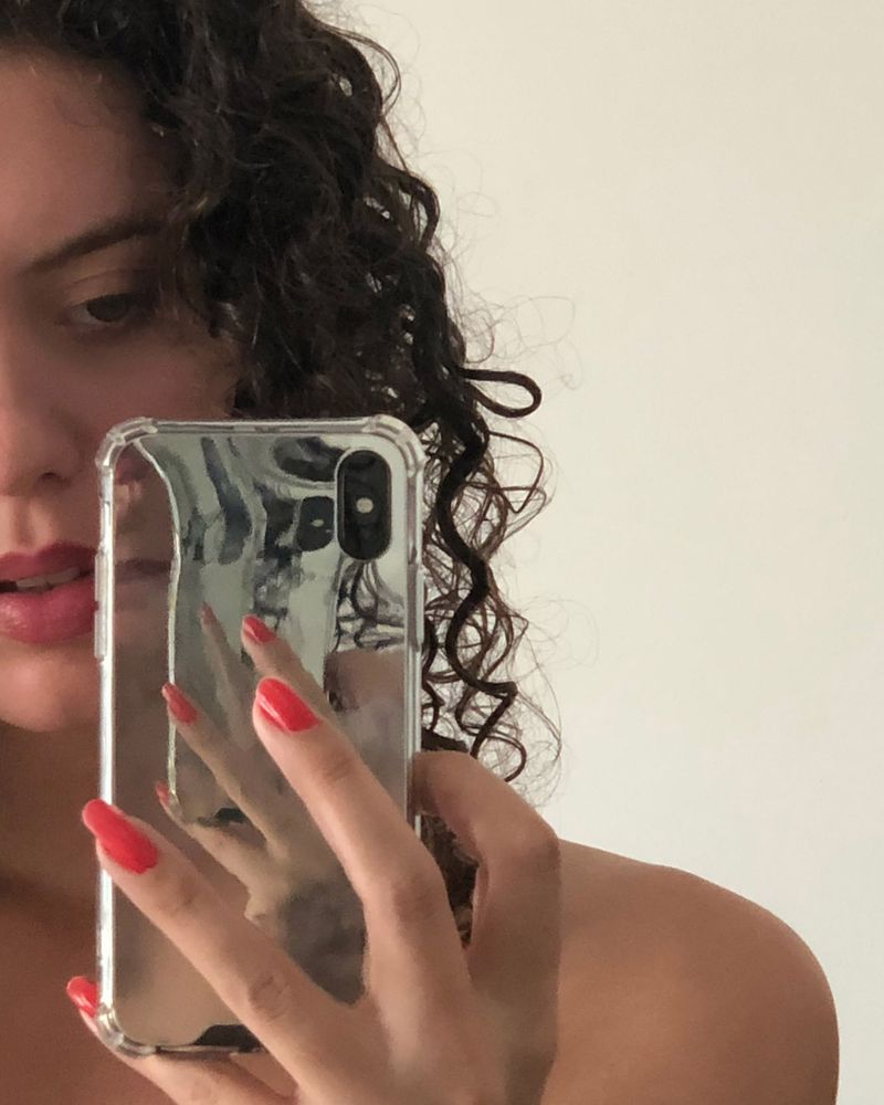 image of model taking a selfie in a mirror
