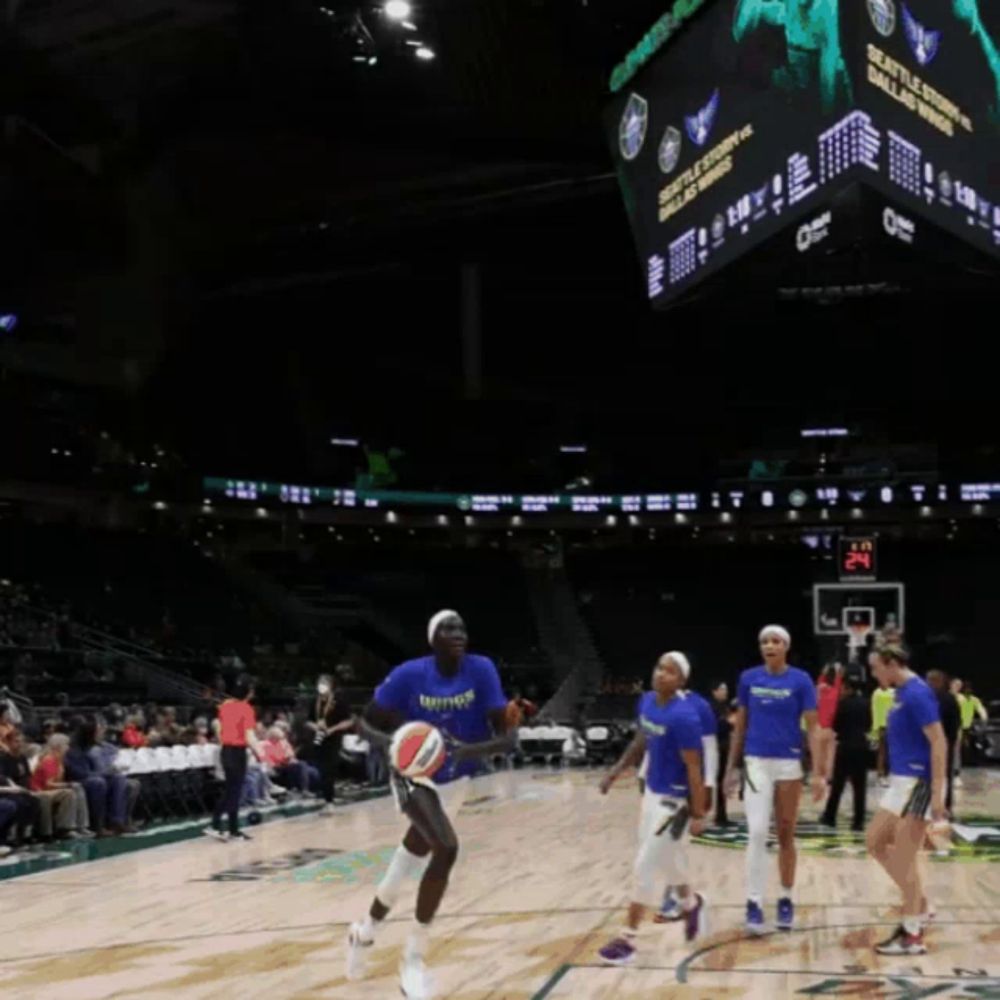 a basketball player wearing a blue shirt that says wings