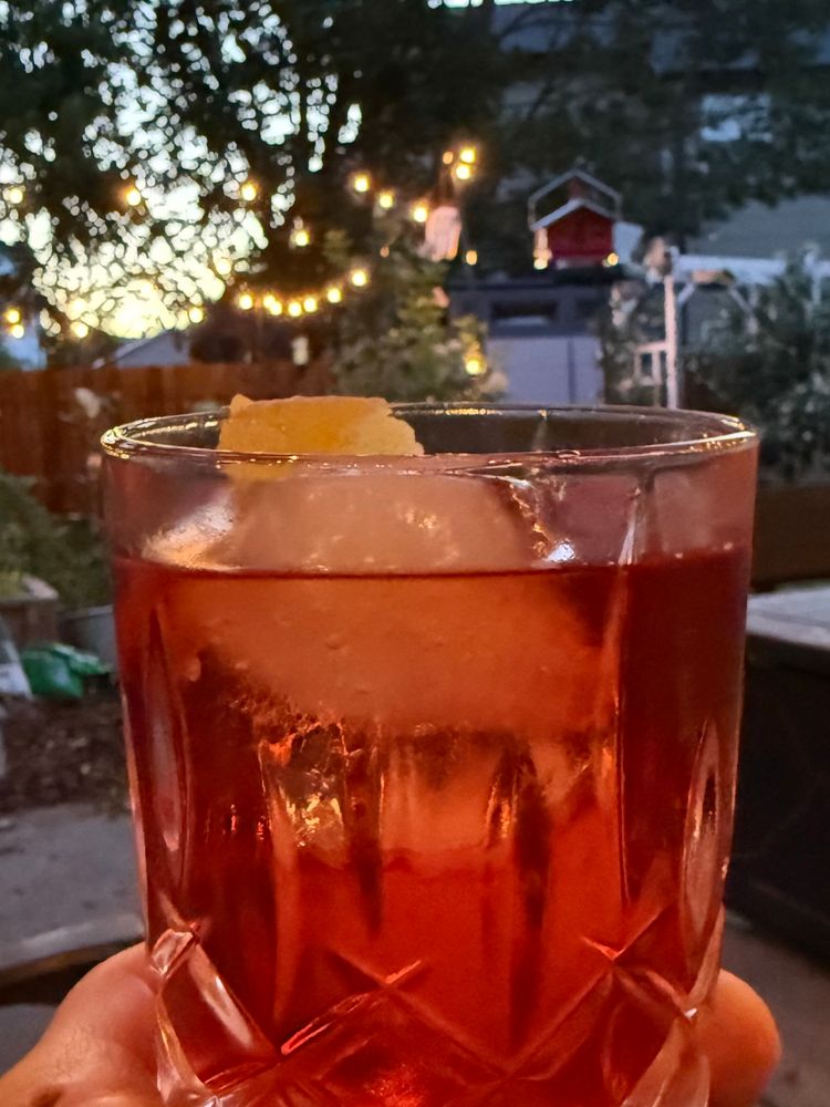 Boulevardier cocktail on a patio just past sunset 