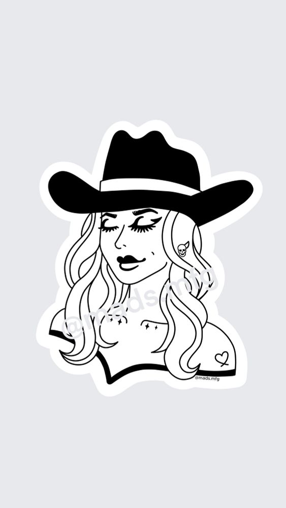 Goth cowgirl bust with black eyeliner and heart tattoo. She has a black cowboy hat on and wavy hair. She is wearing a skull earrings. 