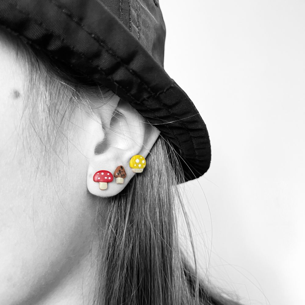 Mushroom earrings on ear