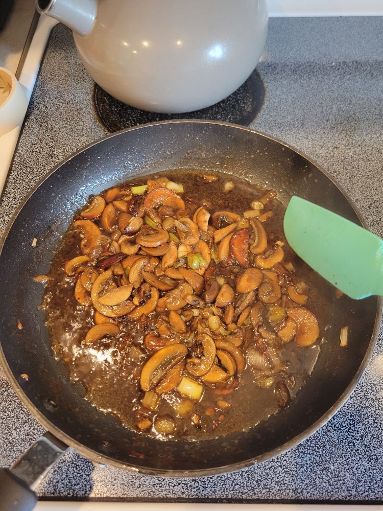 Mushrooms in a pan with dark sauce