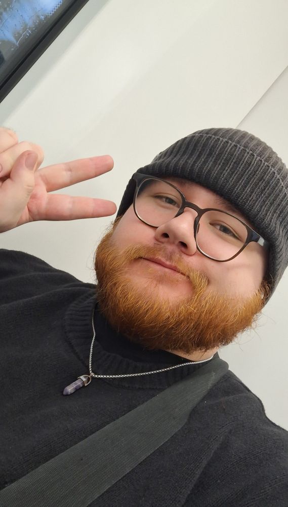 Me smiling and giving a peace sign 