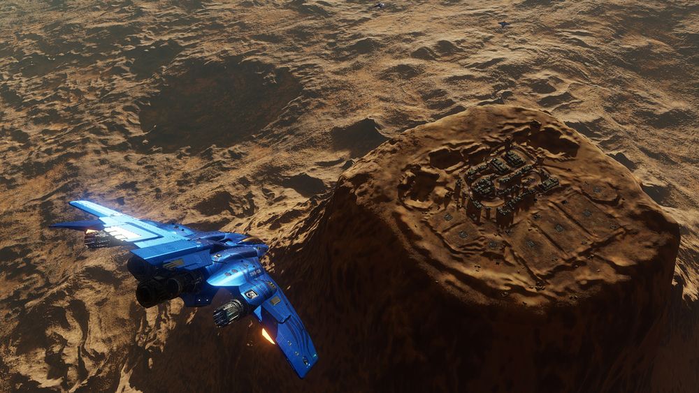 A Zorgon Peterson Mandalay explorer ship in a brilliant shiny blue livery, arriving at the construction site of Devil's Tower ground station in Hyades Sector ZU-Y d68. Part of an impromptu get together of like-minded Mandalay owners.