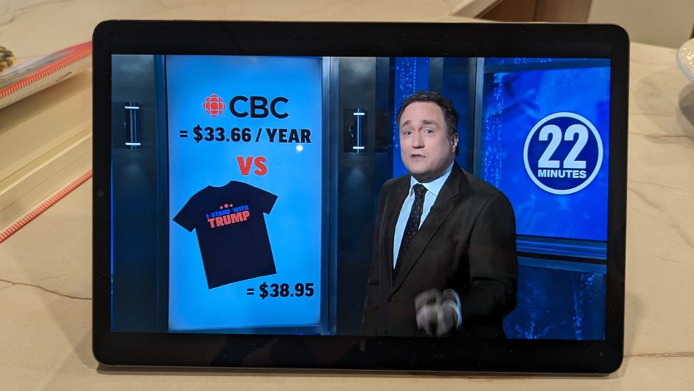 Photograph of a screen showing a still from 22 minutes. Mark Critch giving the comparison in my post