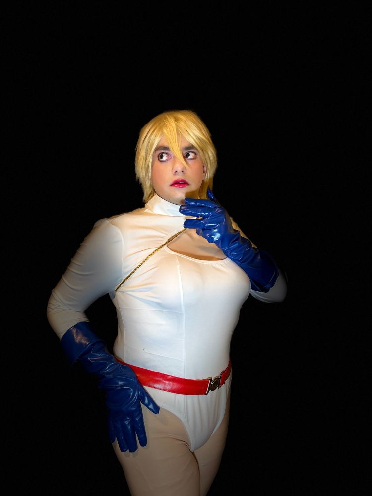 Me in my Power Girl cosplay looking off to the side while posing. 