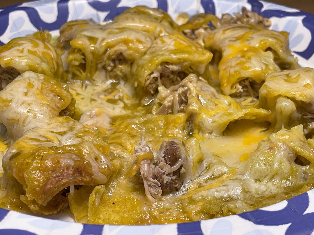 A paper plate full of cheesy gooey chicken verde enchilada bites