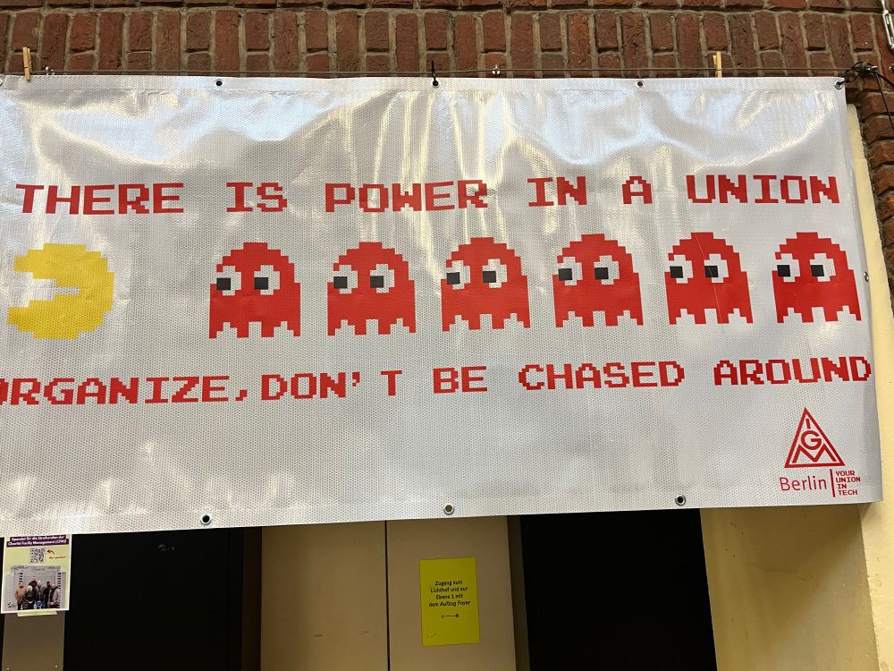 Banner that says There is power in a union. Organize, don’t be chased around. Featuring red ghosts chasing Pac-Man.  