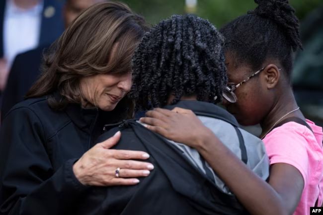 U.S. Vice President Kamala Harris, left, embraces community members as she surveys the damage from Hurricane Helene, in the Meadowbrook neighborhood of Augusta, Georgia, Oct. 2, 2024. https://www.voanews.com/a/biden-surveys-hurricane-helene-s-damage-in-southeastern-us-states-/7809719.html
