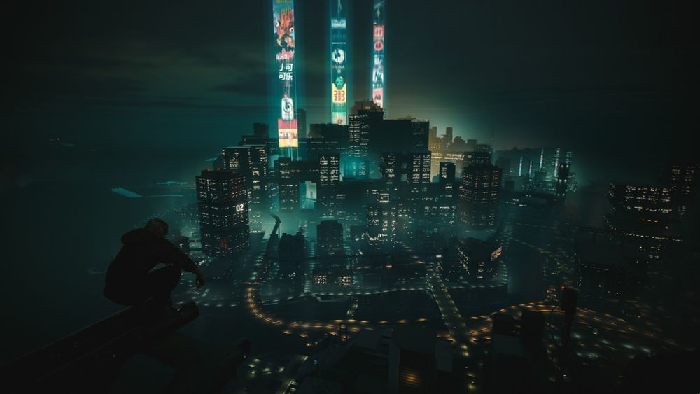 A virtual photograph from Cyberpunk 2077. It shows a panorama of Night City during the night. In the foreground, V is squatting on a beam high in the air, looking down at the city.