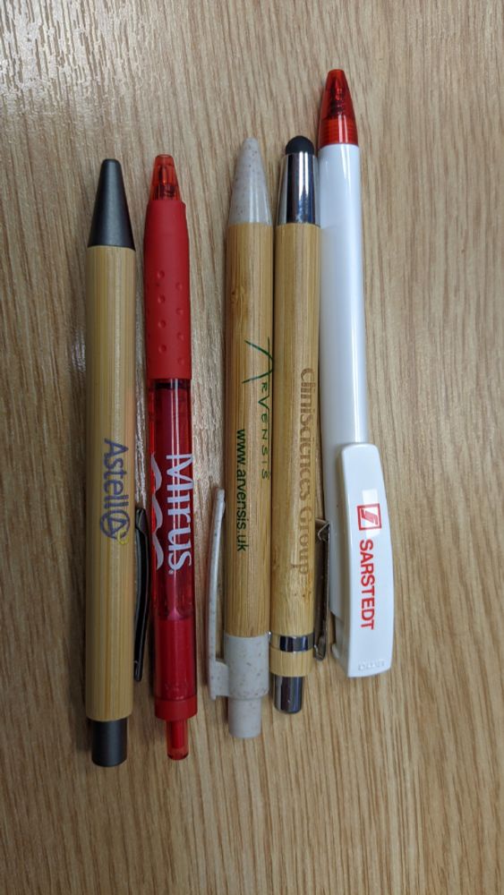 Picture of 5 pens from 5 different laboratory related companies.