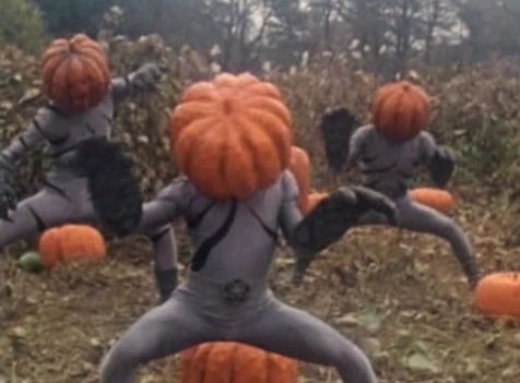 Three pumpkin headed baddies in a foggy pumpkin patch doing a spoooooky dance!