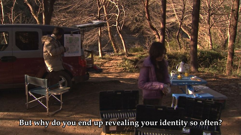 Kasumi and Hibiki setting up camp in the woods. Kasumi: "But why do you end up revealing your identity so often?"
